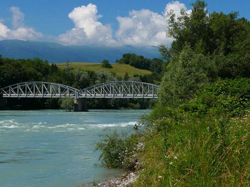 A metal arch bridge that crosses the Rhône River and links Switzerland to France