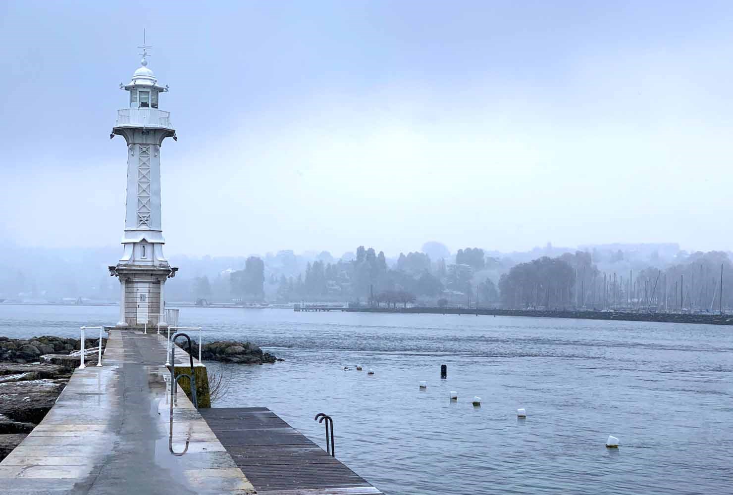 the Bains des Paquis lighthouse in the winter mist