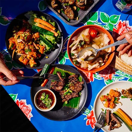 colourful table setting filled with thai food plates from soi restaurant 