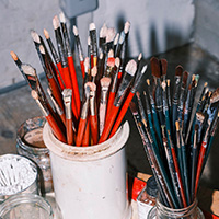 A collection of paintbrushes in a Geneva artist's studio during a Studio Visit
